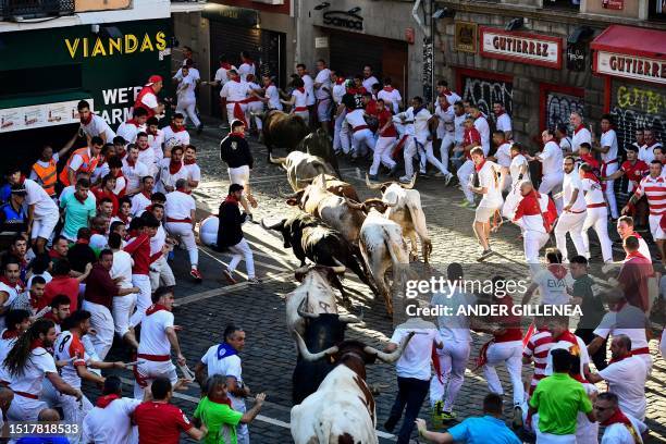 Participants run ahead of bulls during the "encierro" of the San Fermin festival in Pamplona, northern Spain, on July 10, 2023. Thousands of people...