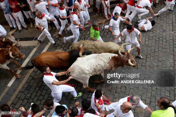 Participants run ahead of bulls during the "encierro" of the San Fermin festival in Pamplona, northern Spain, on July 10, 2023. Thousands of people...