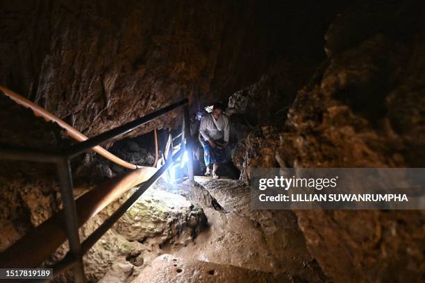 Visitors walk inside the Tham Luang Cave in Mae Sai district in the northern province of Chiang Rai on July 10 during an event to mark the five-year...