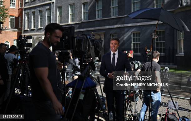 Members of the media work in Downing Street in central London on July 10 ahead of the arrival of US President Joe Biden. US President Joe Biden was...