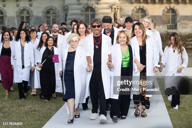 Fashion designer Pierpaolo Piccioli and the Valentino team acknowledge the applause of the audience after the Valentino Haute Couture Fall/Winter...