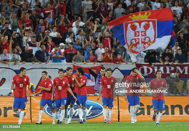 Serbia's players celebrate after scoring a goal during the FIFA 2014 World Cup qualifying football match between Serbia and Wales at the Karadjordje...