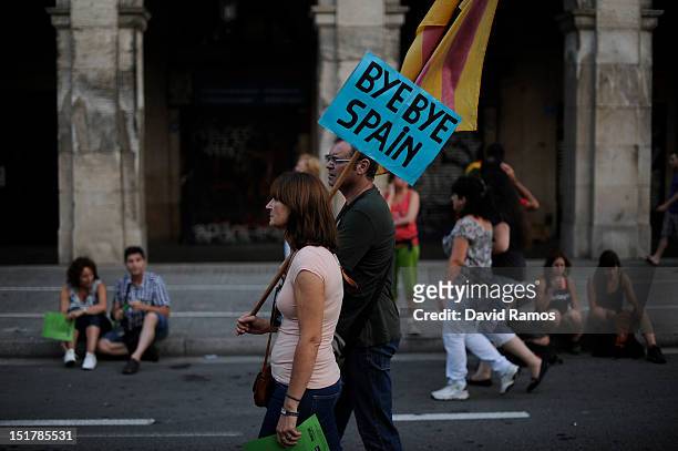 Couple holds a banner that reads 'Bye Bye Spain' during a demonstration calling for independence during the Catalonia's National Day on September 11,...
