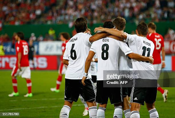Germany's Mesut Ozil celebrates with his teammates after scoring a penalty against Austria during the FIFA 2014 World Cup qualification football...