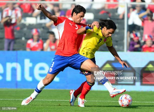 Chilean defender Marco Gonzalez vies for the ball with Colombian forward Radamel Falcao during their Brazil 2014 FIFA World Cup South American...