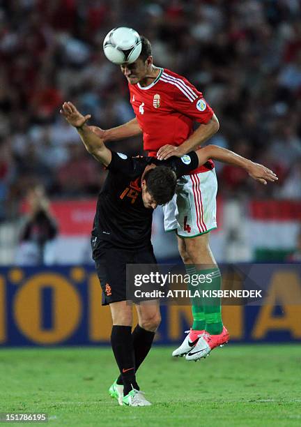 Hungary's Roland Juhász vies with Netherlands' Joris Mathijsen during the World Cup 2014 qualifying football match Hungary vs The Netherlands in...