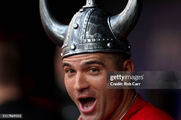 Joey Votto of the Cincinnati Reds celebrates in the dugout after hitting a solo home run against the Cincinnati Reds in the second inning at...