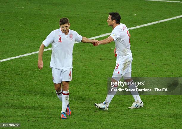 Steven Gerrard of England passes theCaptains armband to Frank Lampard after being shown a red card and sent off during the FIFA 2014 World Cup...