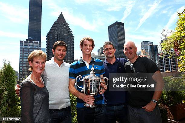 Andy Murray of Great Britain poses with the US Open Championship trophy next to mother Judy Murray, Daniel Vallverdu, Andy Ireland and Jez Green...