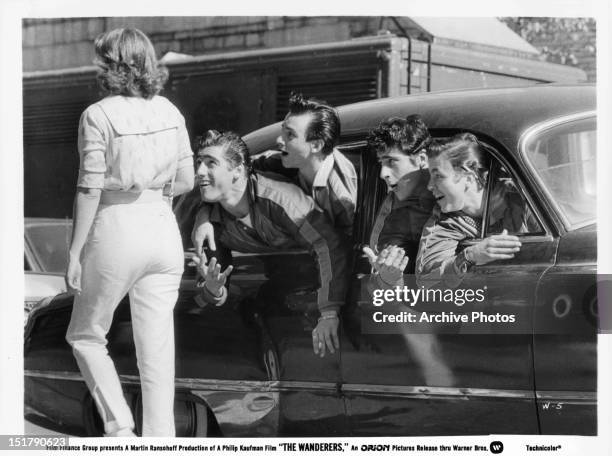 Ken Wahl and his crew gawking at woman passing by in a scene from the film 'The Wanderers', 1979.