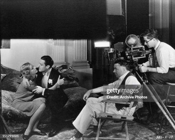 Director Clarence Brown watching seen between Greta Garbo and John Gilbert from the film 'Woman Of Affairs', 1928.