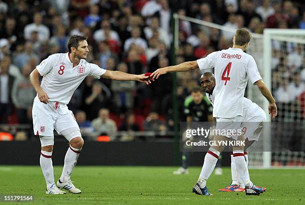 England's captain Steven Gerrard hands the captain's armband to Frank Lampard after receiving a red card during the 2014 World Cup qualifying...
