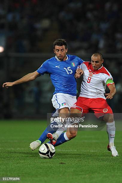Andrea Barzagli of Italy competes with Michael Mifsud of Malta during the FIFA 2014 World Cup qualifier match between Italy and Malta on September...