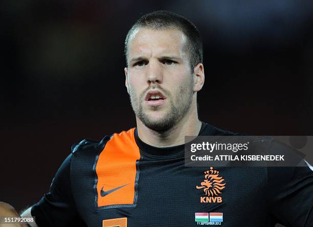 The Netherlands' Ron Vlaar listens to his national anthem during the World Cup 2014 qualifying football match Hungary vs The Netherlands in Puskas...