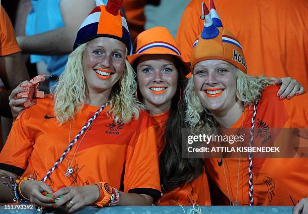 Dutch football fans pose priort to the World Cup 2014 qualifying football match Hungary vs The Netherlands in Puskas stadium of Budapest on September...