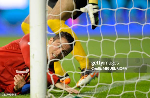 Portuguese forward Cristiano Ronaldo falls on the pitch close to Azerbaijan's goalkeeper during the FIFA World Cup 2014 qualifying football match...