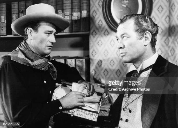 John Wayne and Ward Bond stare at each other in a scene from the film 'Tall In The Saddle', 1944.