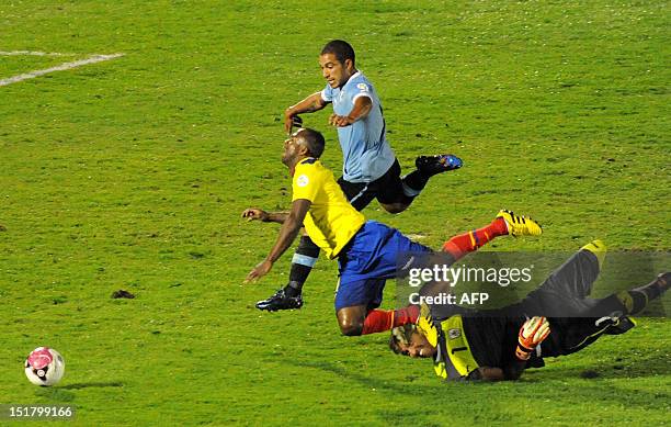 Ecuadorean forward Christian Benitez is marked by Uruguayan goalkeeper Fernando Muslera and Uruguayan midfielder Walter Gargano during their Brazil...