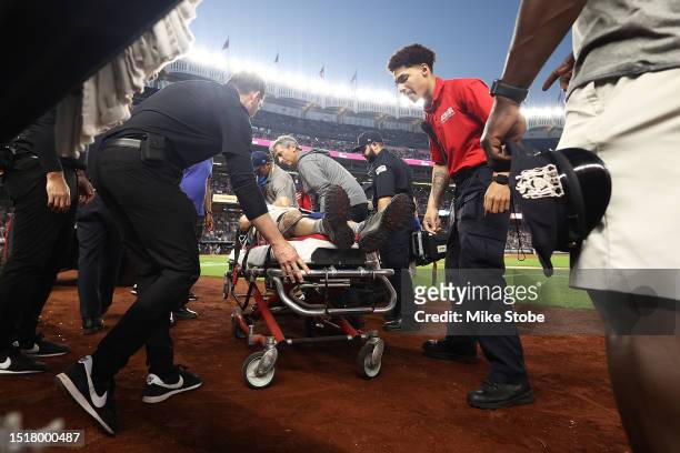 Camera man is carted off the field after getting hit by an errant throw in the fifth inning during the game between the New York Yankees and the...