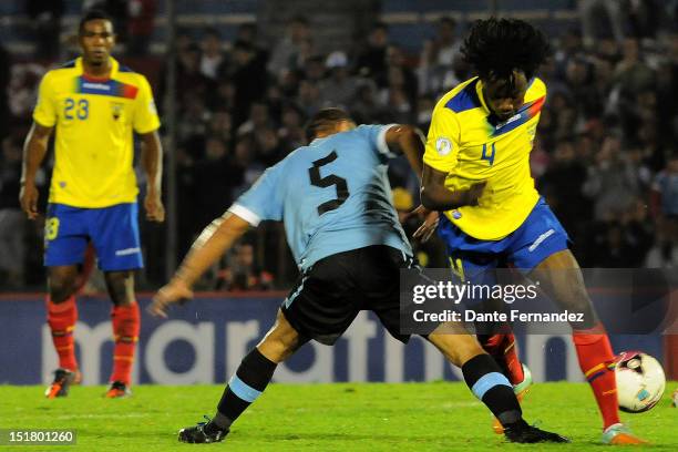 Walter Gargano of Uruguay struggles for the ball with Juan Carlos Paredes of Ecuador during a match between Ecuador and Uruguay as part the South...