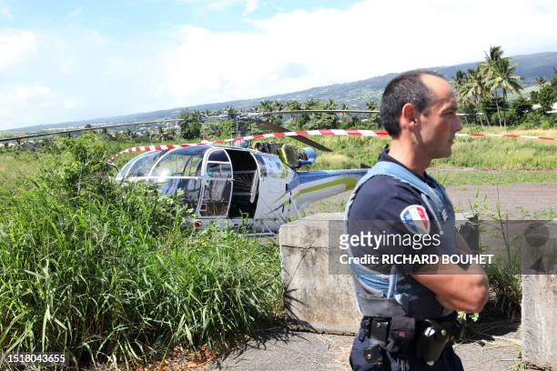 Policement stand, on April 27, 2009 in Saint-Denis de la Reunion, on the French Indian Ocean island of La Reunion, near the helicopter hidjacked for...