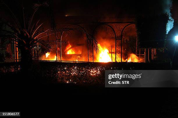 Car vehicle burns after it was set on fire inside the US consulate compound in Benghazi late on September 11, 2012. An armed mob protesting over a...