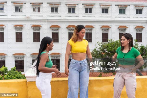 happy multiracial female friends dancing on the street in the city - amigos baile bildbanksfoton och bilder