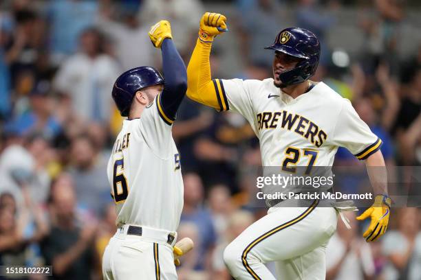 Willy Adames of the Milwaukee Brewers celebrates with teammate Owen Miller after hitting a solo home run against the Chicago Cubs in the sixth inning...