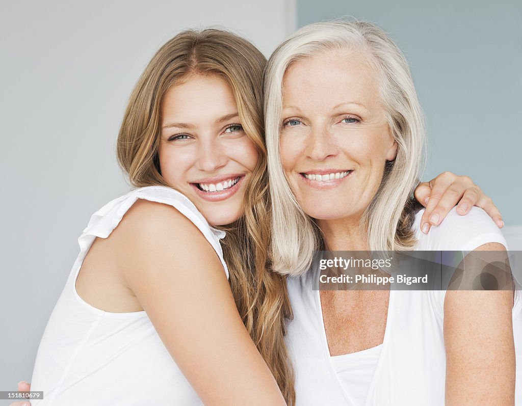 Portrait of smiling mother and daughter hugging