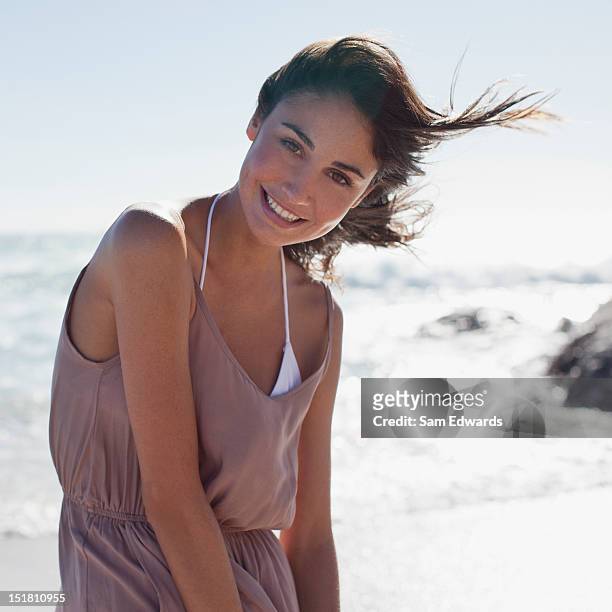 portrait of smiling woman on sunny beach - beautiful woman beach stock pictures, royalty-free photos & images