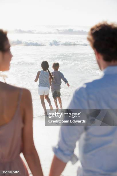 family on sunny beach - afrikanisches kind beobachtet natur stock-fotos und bilder