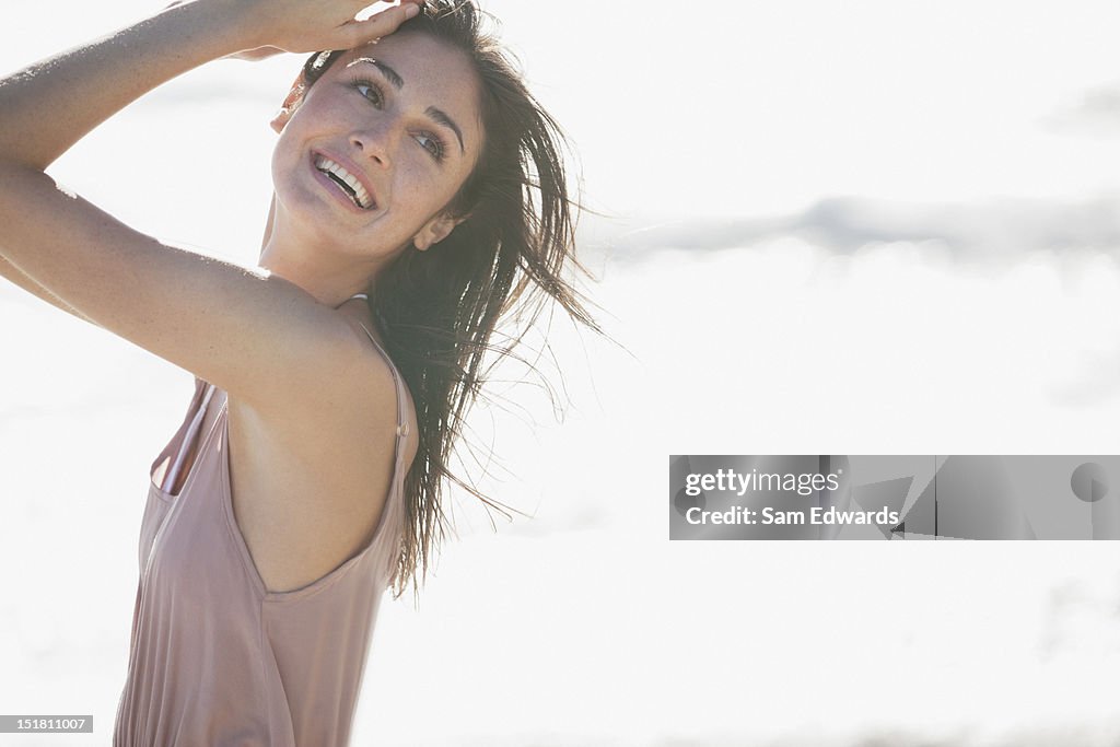 Smiling woman on sunny beach