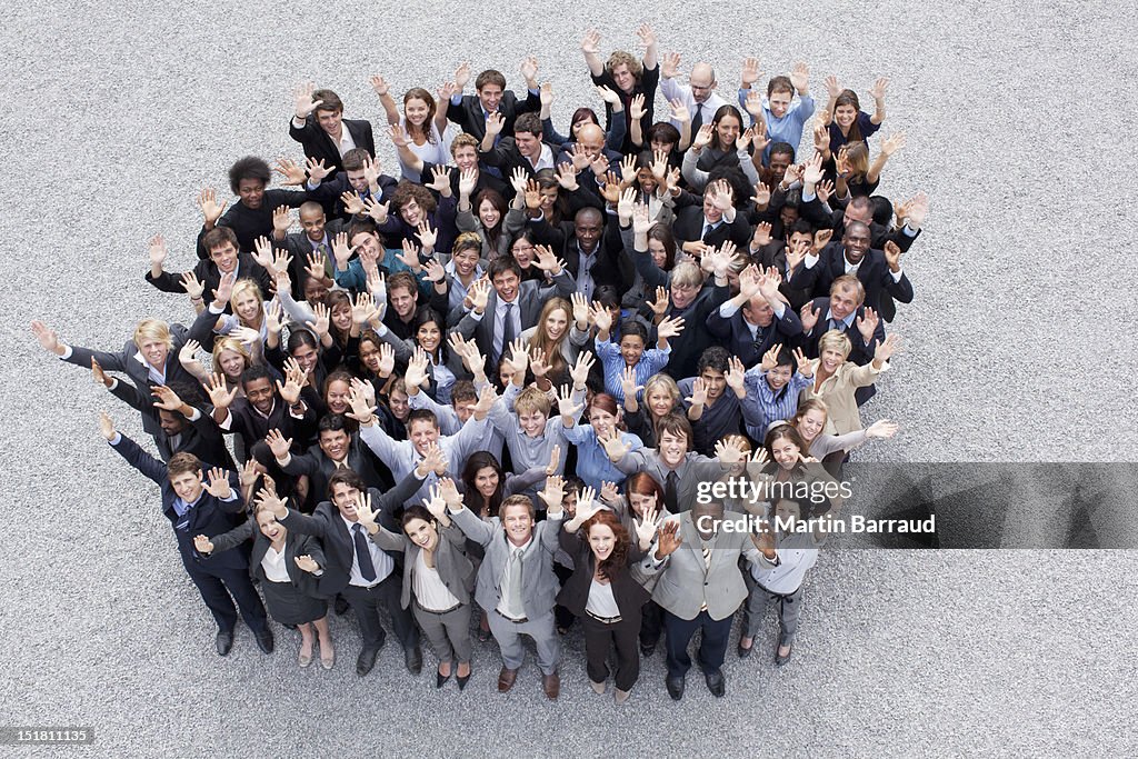Portrait of waving business people