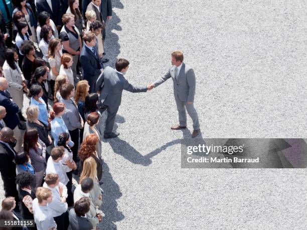 businessman shaking mans hand in crowd - leaders shaking hands politics politicians stock pictures, royalty-free photos & images