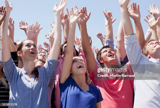 cheering crowd with arms raised - crowd looking up stock pictures, royalty-free photos & images