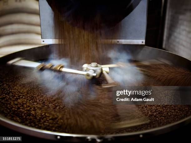 coffee beans falling into steaming roasting machine - coffee grinder stock pictures, royalty-free photos & images