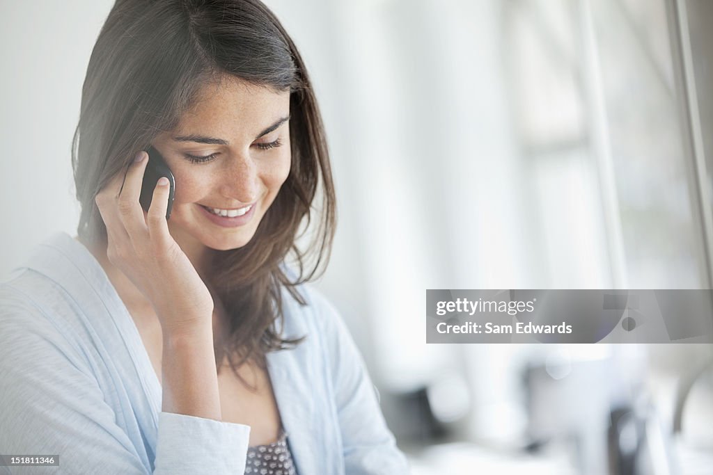 Smiling woman talking on cell phone