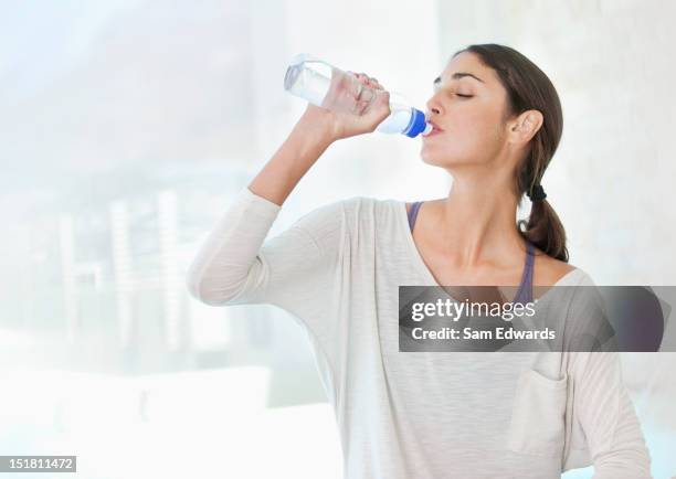 woman drinking from water bottle - women drinking water stock pictures, royalty-free photos & images