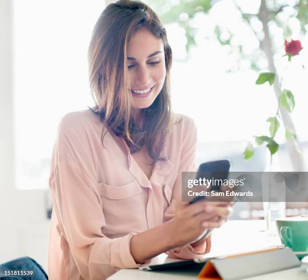 smiling businesswoman checking cell phone - roles in port of call receive interview in taipei stockfoto's en -beelden