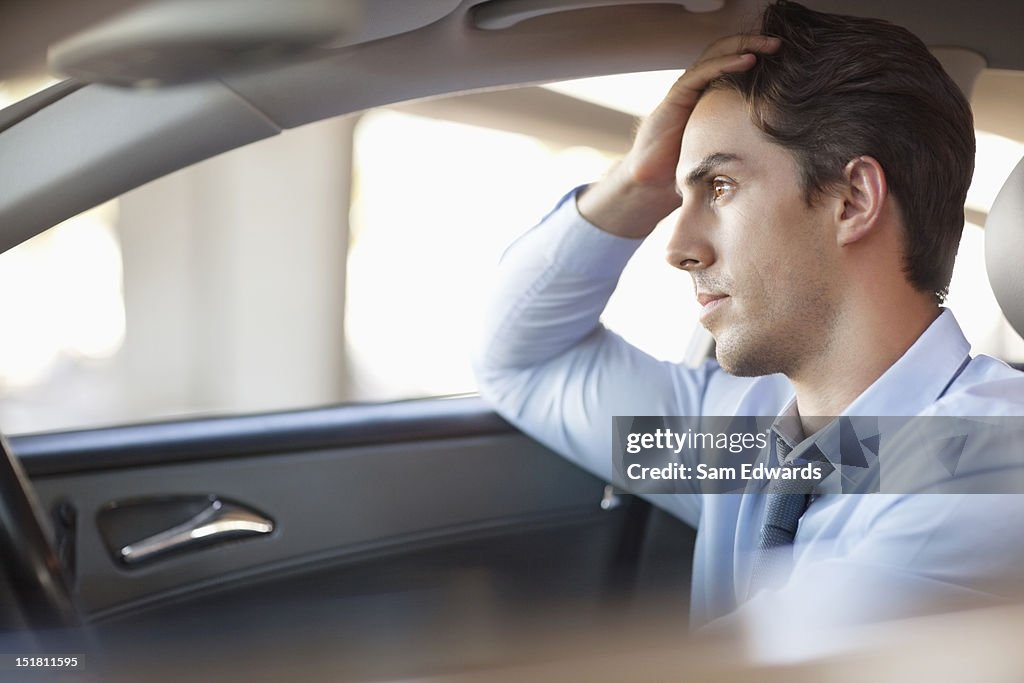 Frustrated businessman driving car