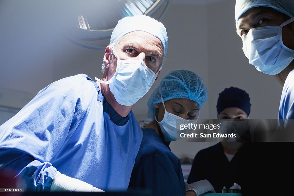 Retrato de médicos cirurgiões, trabalhando em Sala de Cirurgia com Assistência