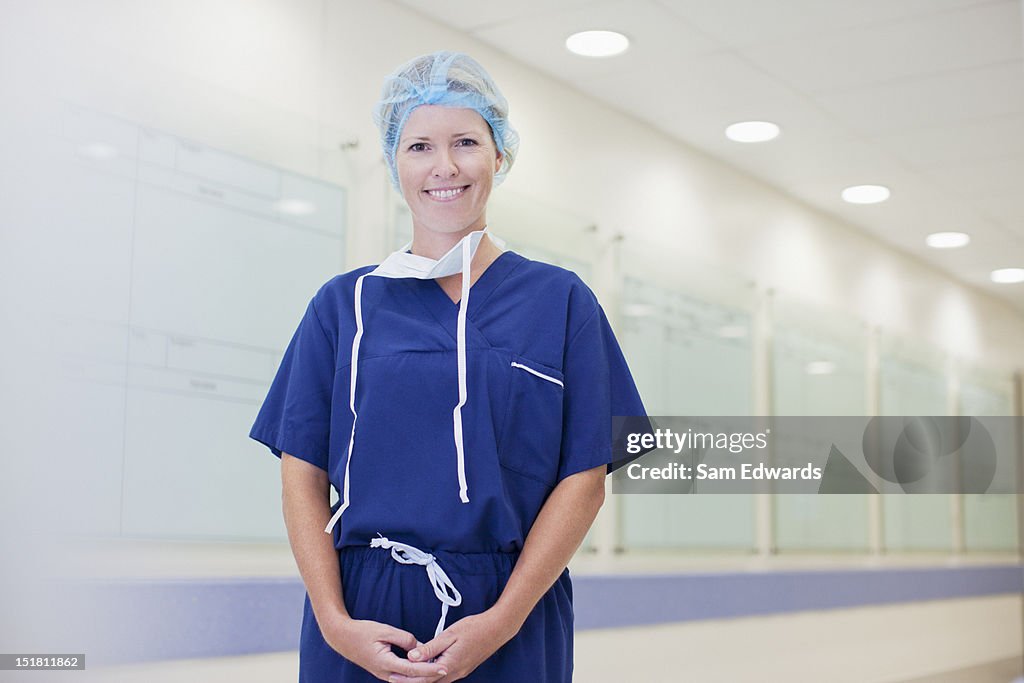 Portrait of smiling nurse in hospital corridor