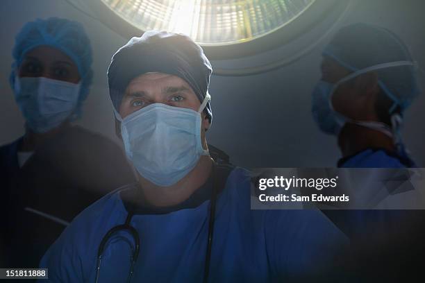 portrait of confident surgeons in operating room - surgical mask man stock pictures, royalty-free photos & images