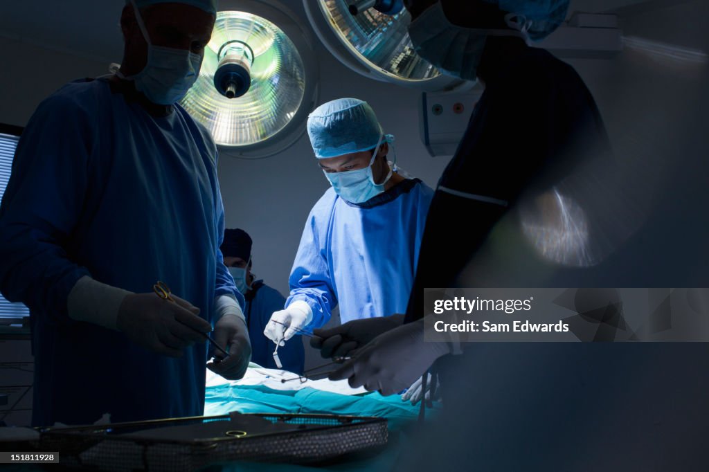Surgeons working in operating room