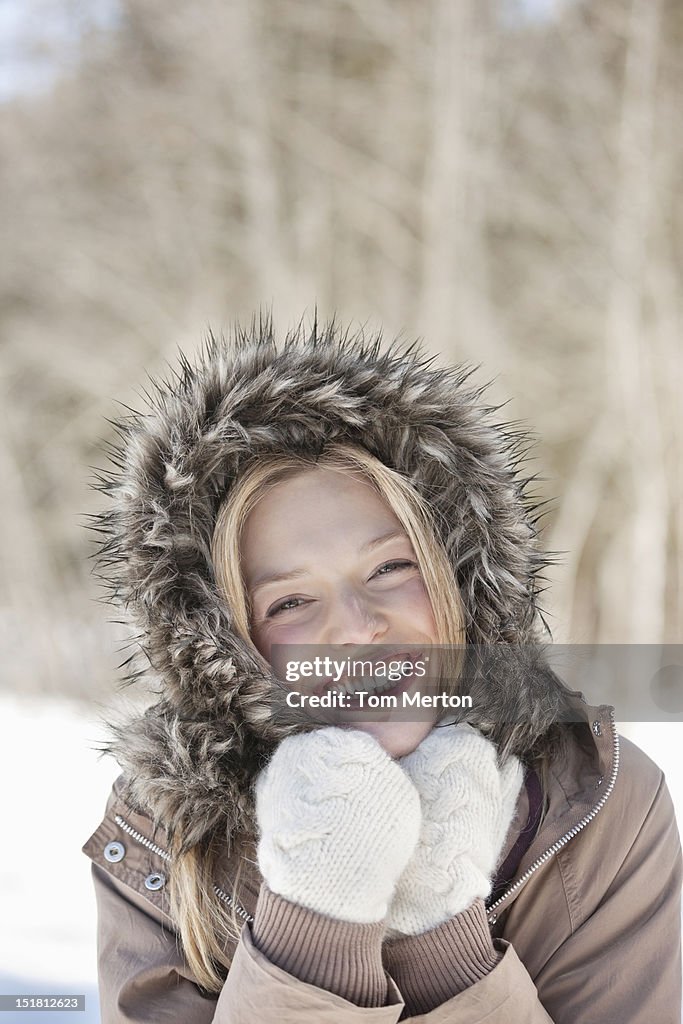 Portrait of smiling woman wearing fur hood coat