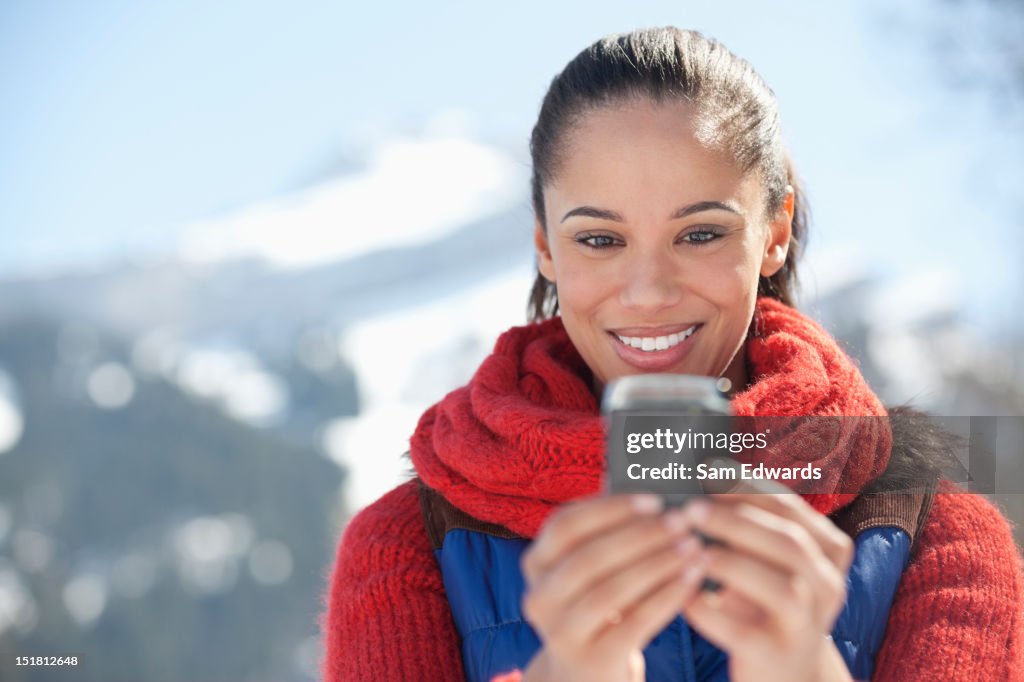 Smiling woman checking cell phone