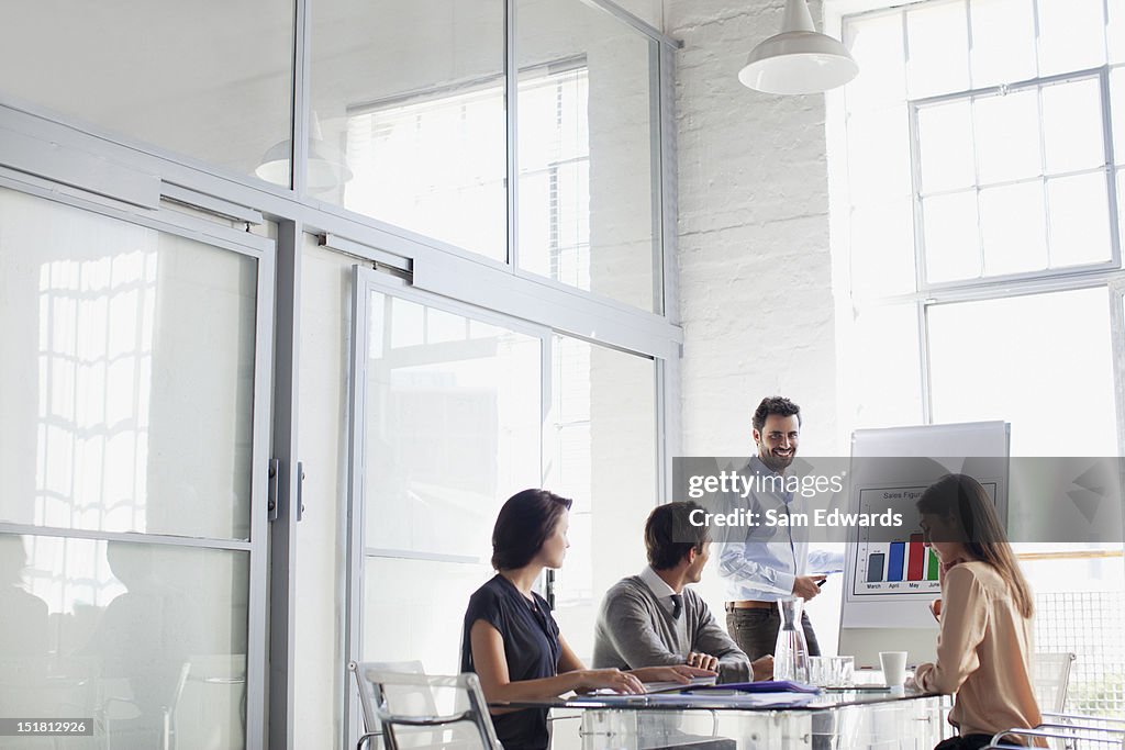 Businessman at chart leading meeting in conference room