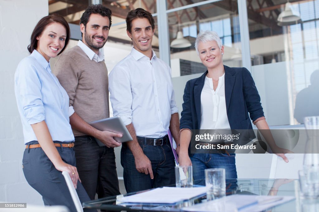 Portrait of smiling business people in conference room