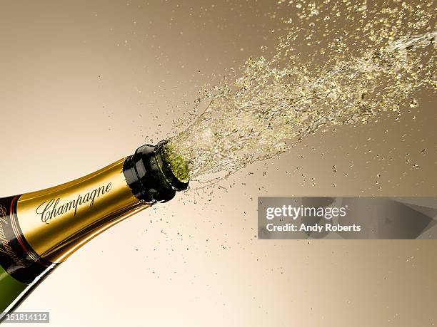 champagne exploding from bottle - champagne popping stock pictures, royalty-free photos & images