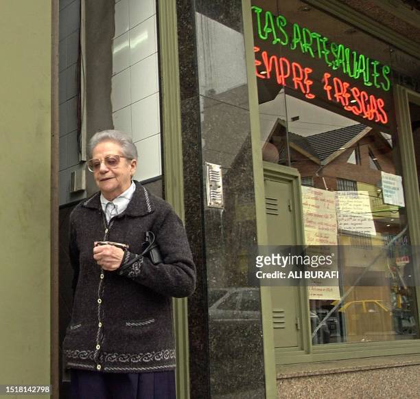 Senior citizen leaves a bakery in the neighborhood of Bodeo where retired civilians have gone to cash their checks, Buenos Aires 24 April 2002. AFP...